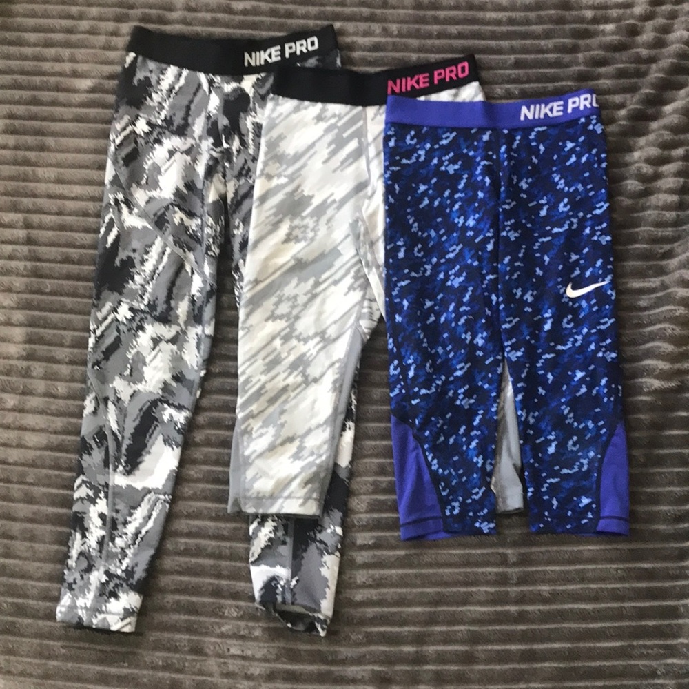 Three pairs of Nike pro leggings.